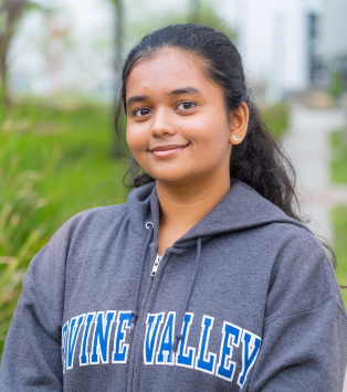 smiling young woman in IVC sweatshirt