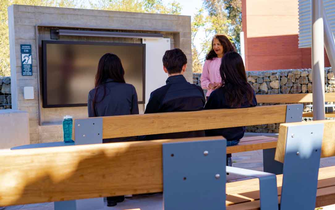 outdoor pavilion with large screens and benches