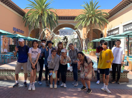 students by large beautiful fountain