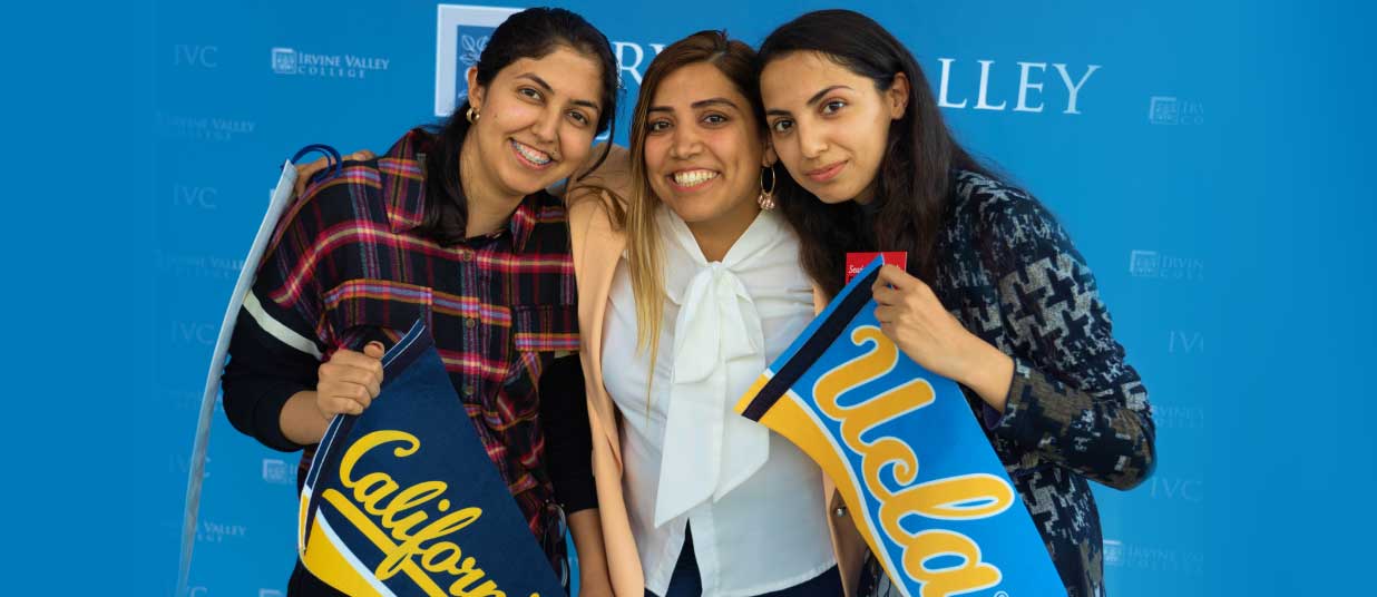 students hold pennants of their transfer universities