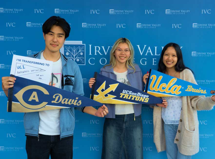 Students hold pennants from universities